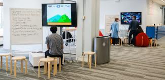 A student playing a video game in the MADD Center. 